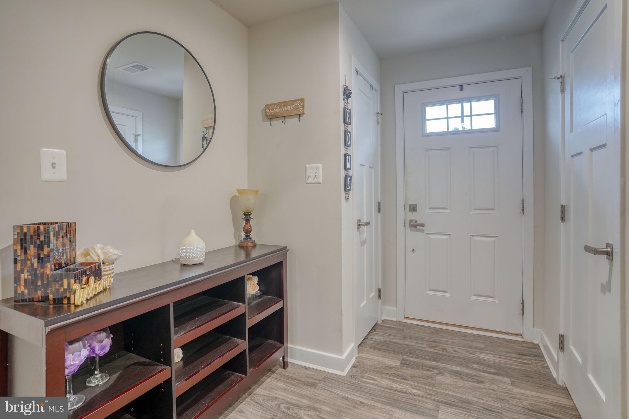 1944 Spearfish Court Newark, DE 19702 - Photo 10 of 44 a view of a hallway with wooden floor and a mirror