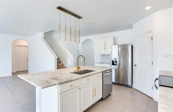 a view of kitchen with granite countertop cabinets and white appliances