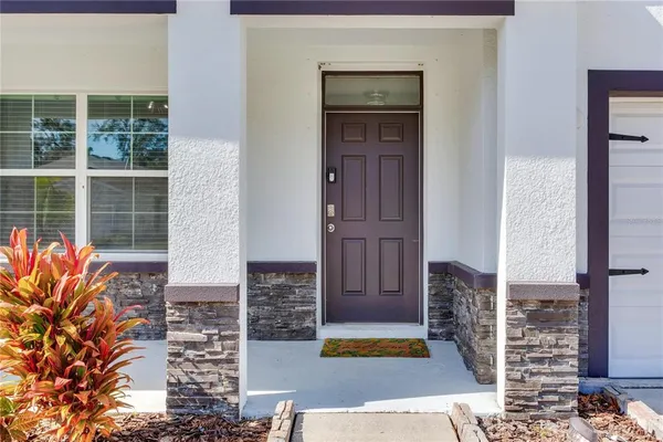 a view of a hallway with wooden floor and closet
