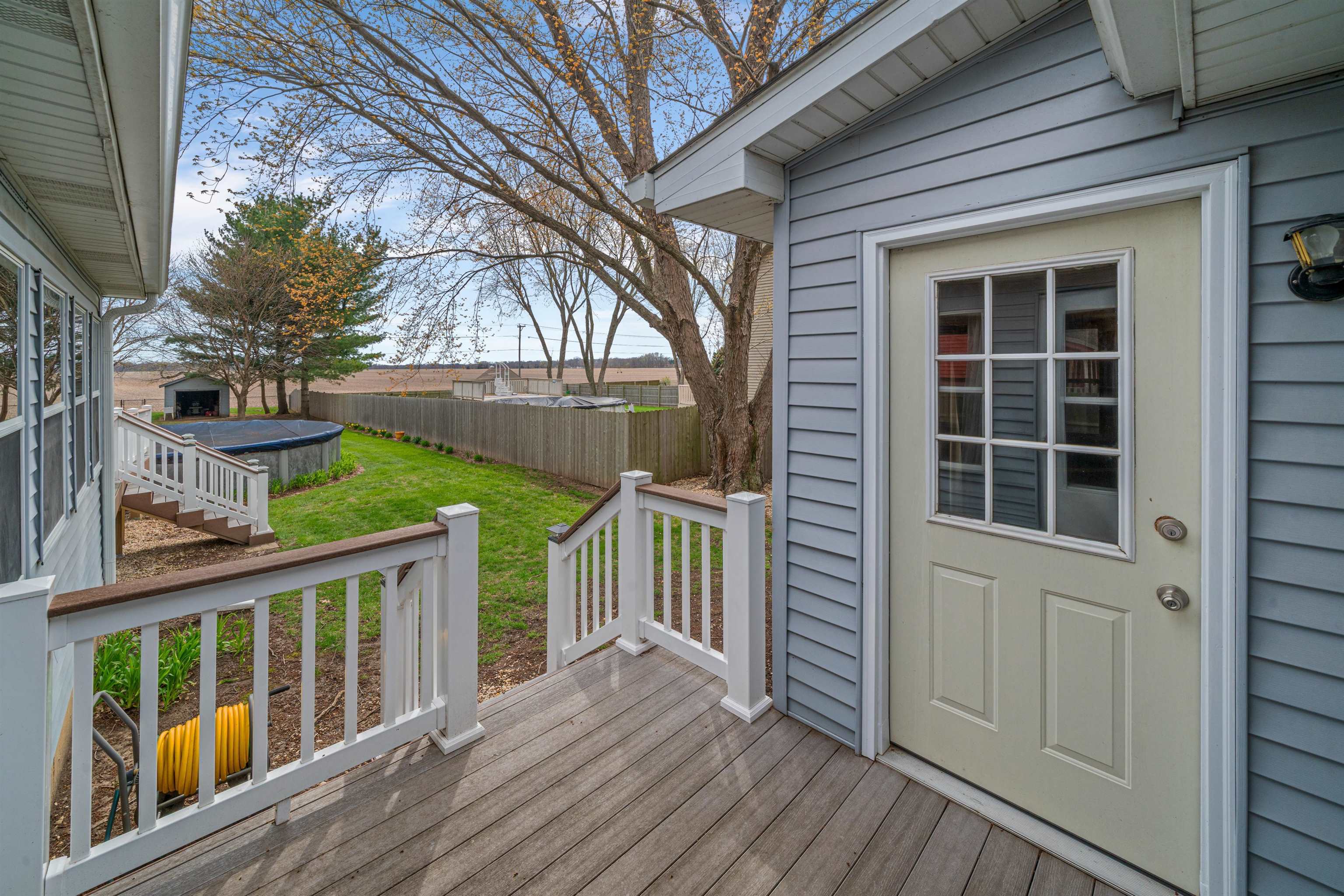 924 Suzy Street Sandwich, IL 60548 - Photo 47 of 48 a view of a house with a wooden deck and a large window