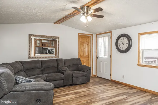a living room with furniture a clock and a window