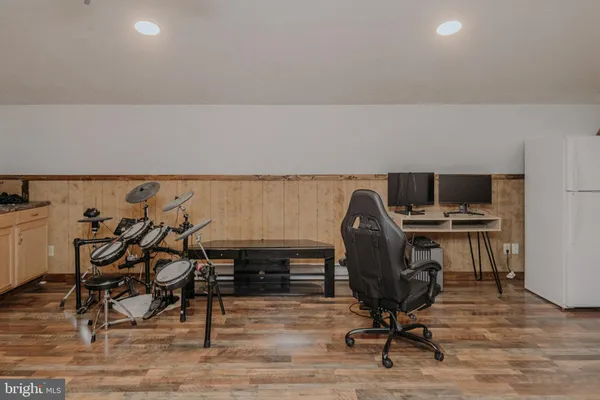 a view of a workspace with furniture and a window