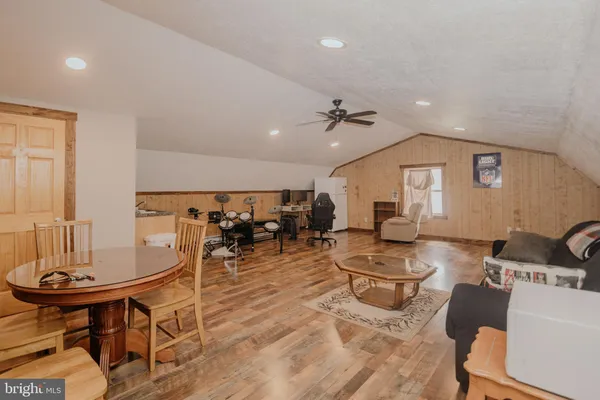 a living room with furniture a flat screen tv and kitchen view