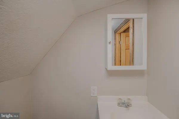 a bathroom with a sink and a window