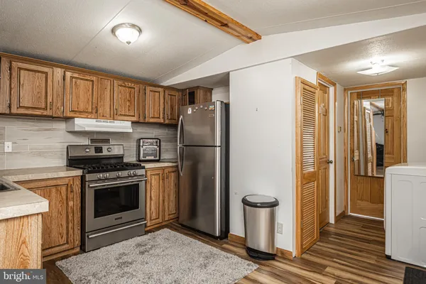 a kitchen with a stove sink and refrigerator