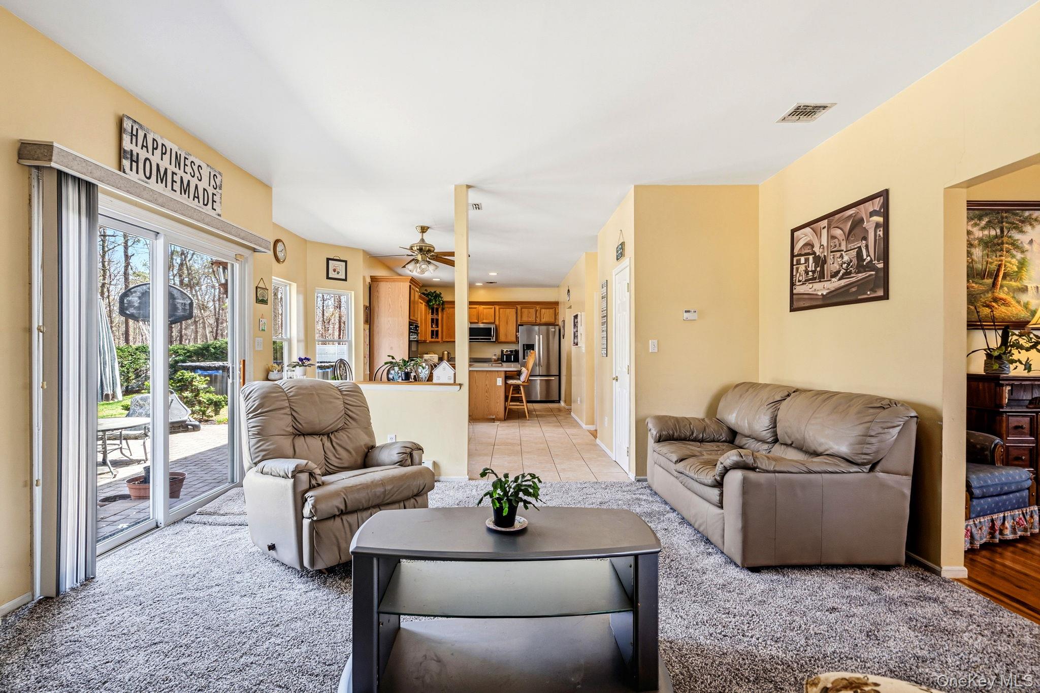 20 Ricky Road Manorville, NY 11949 - Photo 12 of 27 a living room with furniture floor to ceiling window and couch
