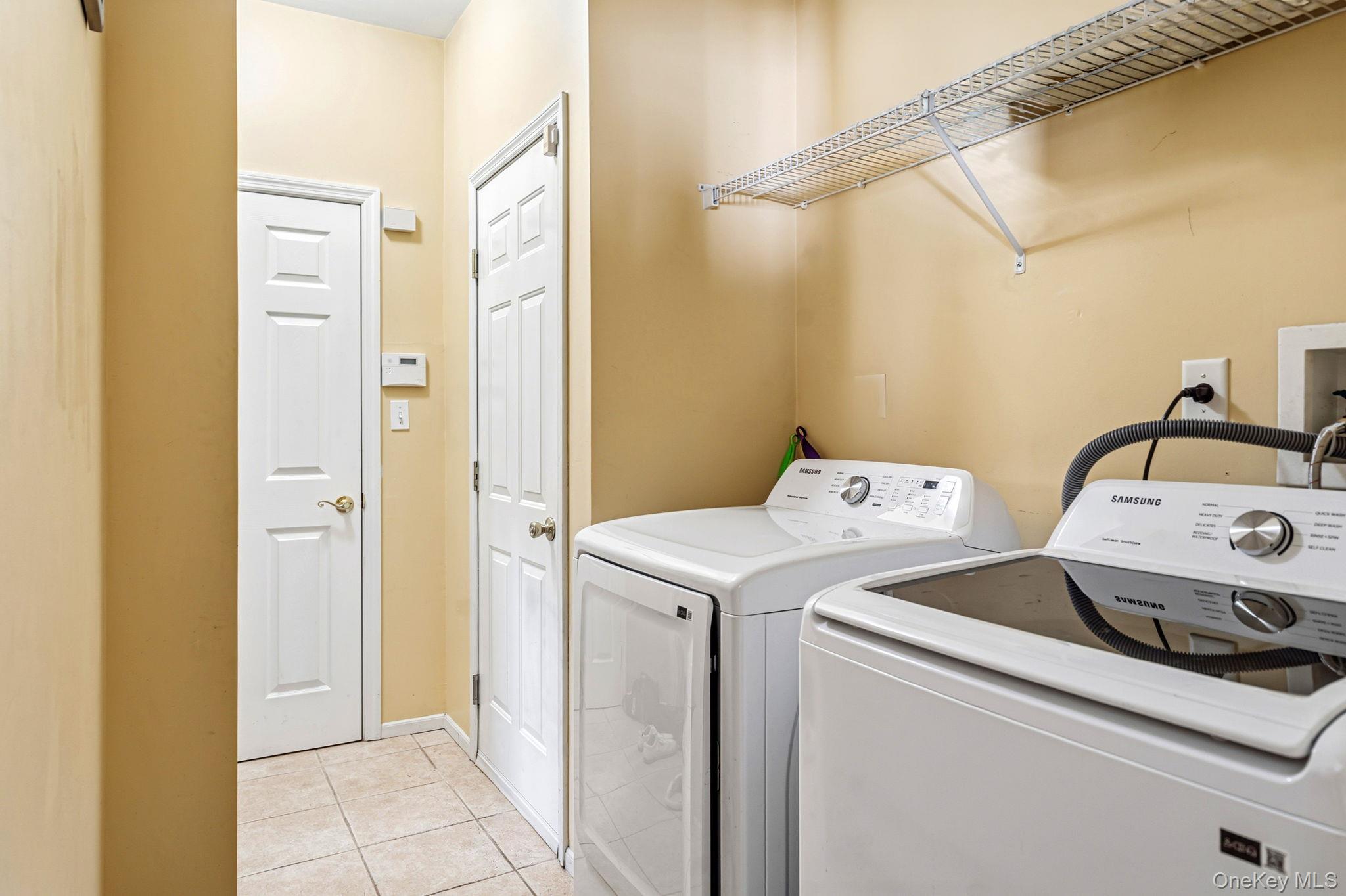 20 Ricky Road Manorville, NY 11949 - Photo 15 of 27 a utility room with dryer and washer