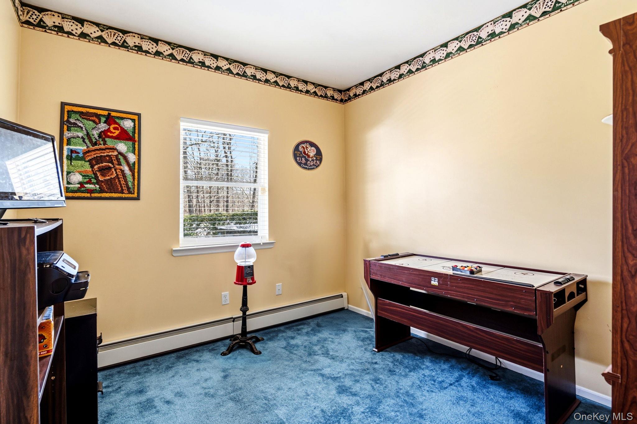 20 Ricky Road Manorville, NY 11949 - Photo 16 of 27 a room with furniture and a window