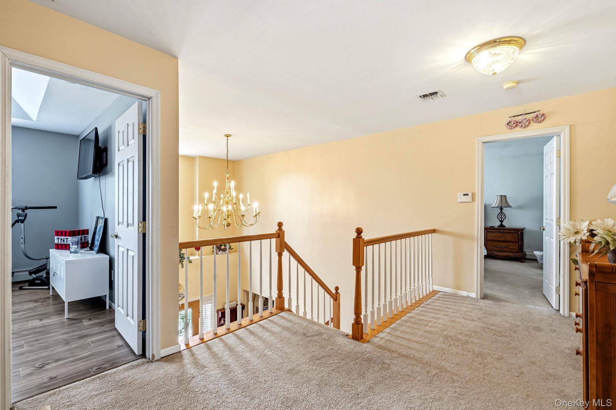 20 Ricky Road Manorville, NY 11949 - Photo 17 of 27 a view of a hallway with livingroom and furniture