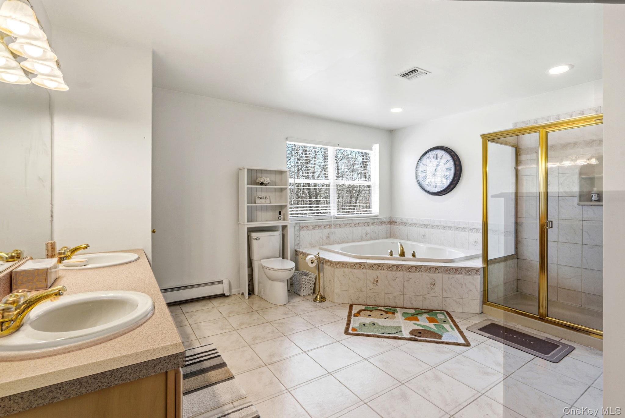 20 Ricky Road Manorville, NY 11949 - Photo 20 of 27 a bathroom with a sink toilet and a mirror