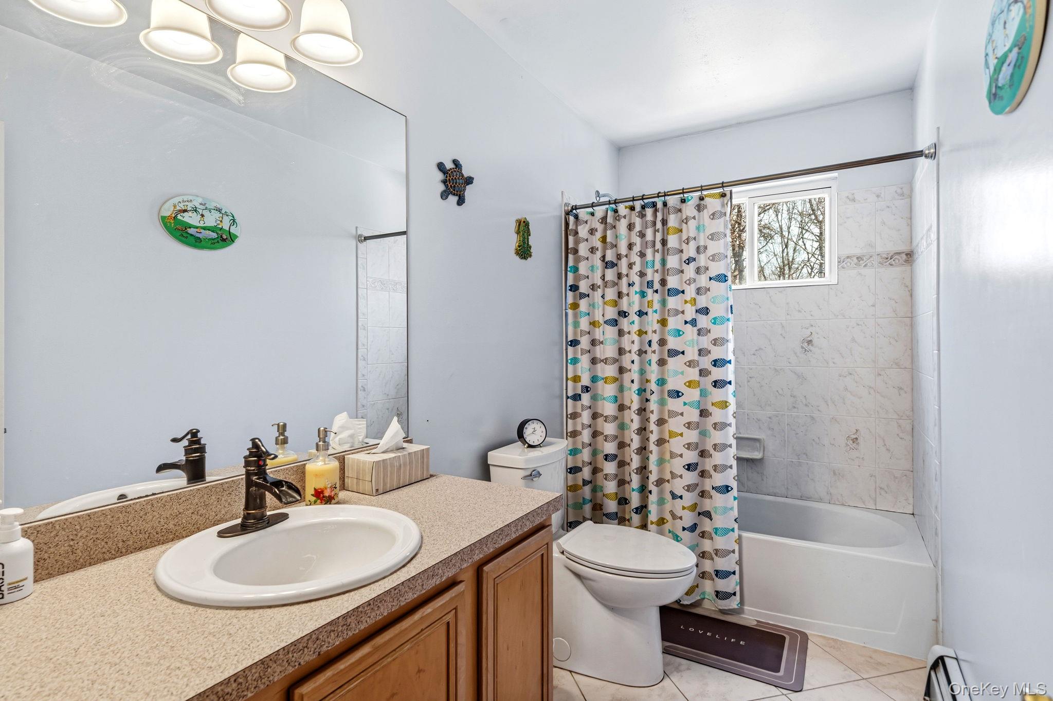 20 Ricky Road Manorville, NY 11949 - Photo 23 of 27 a bathroom with a sink a toilet and shower