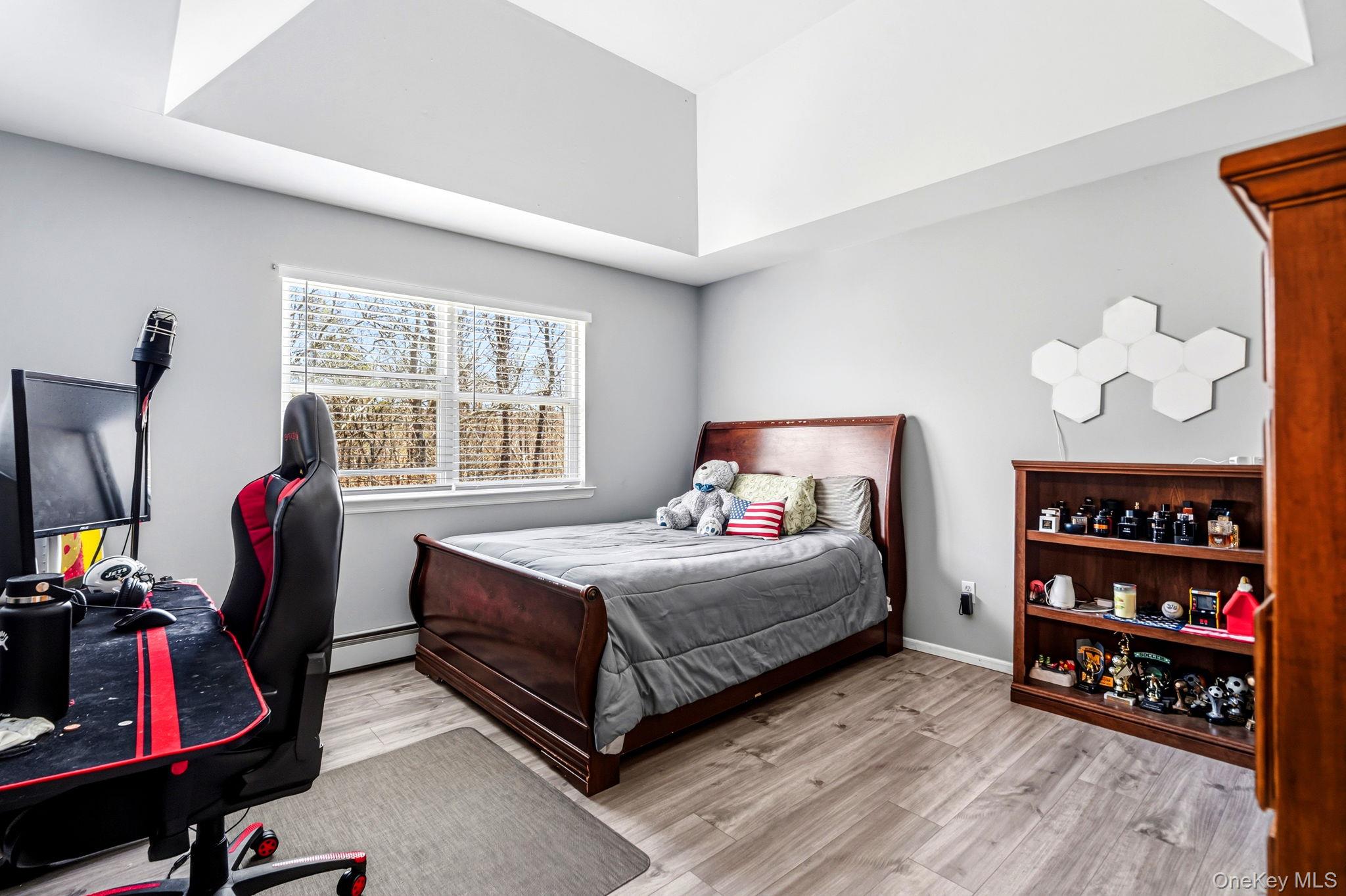 20 Ricky Road Manorville, NY 11949 - Photo 24 of 27 a bedroom with a bed closet and a window