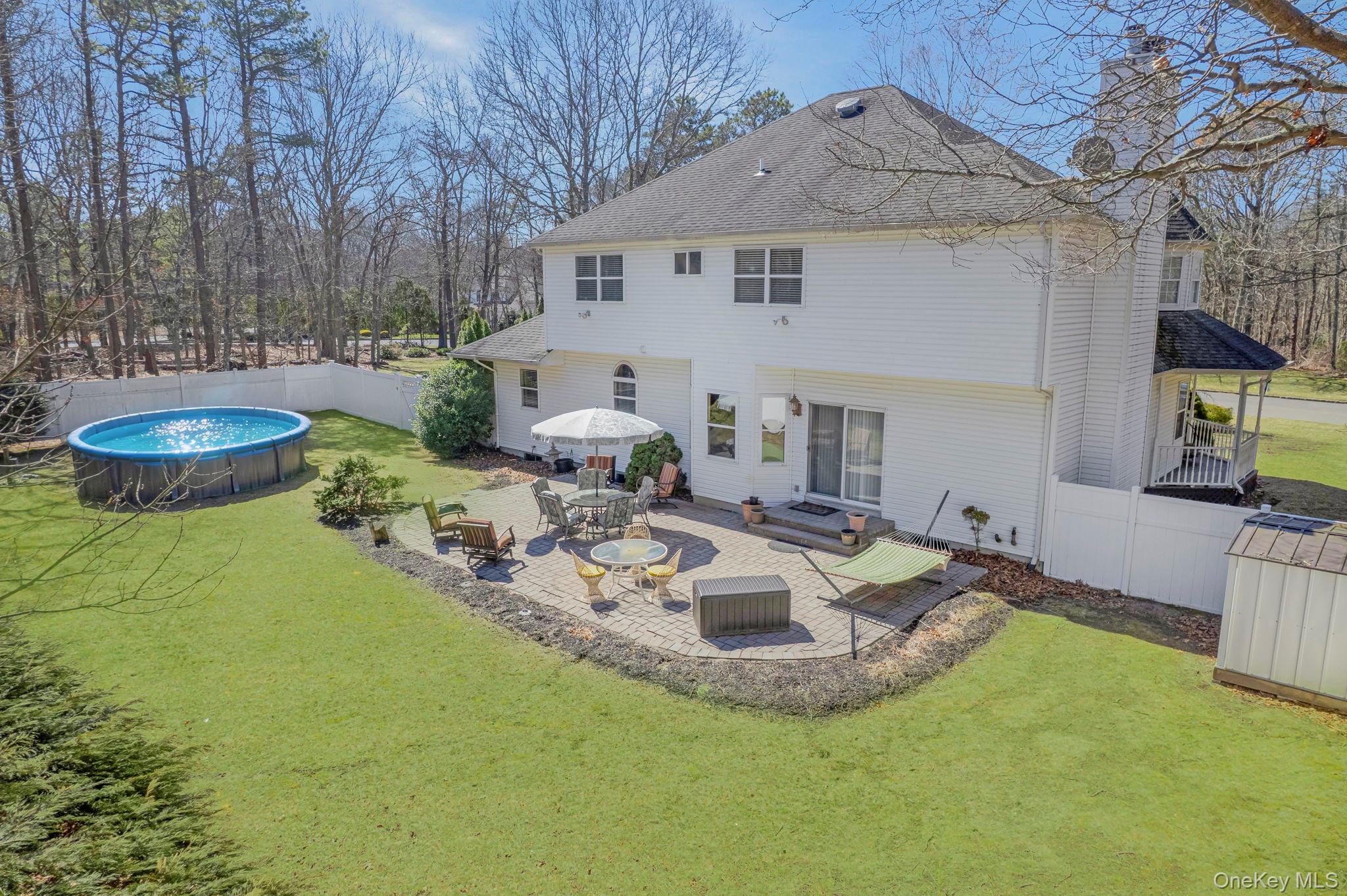 20 Ricky Road Manorville, NY 11949 - Photo 26 of 27 a view of a house with backyard and sitting area
