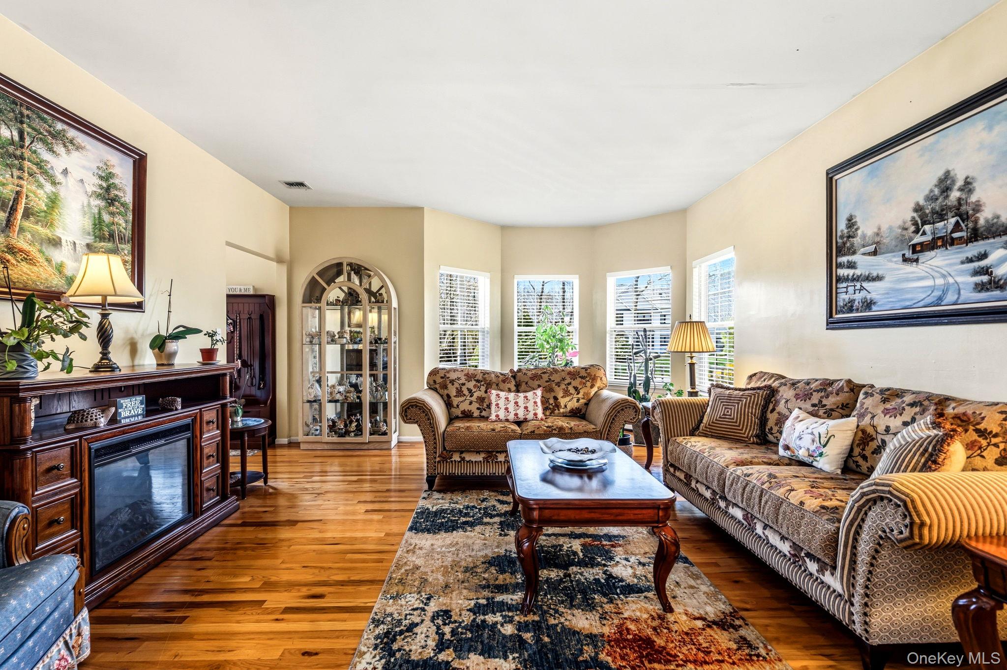 20 Ricky Road Manorville, NY 11949 - Photo 6 of 27 a living room with furniture fireplace and flat screen tv