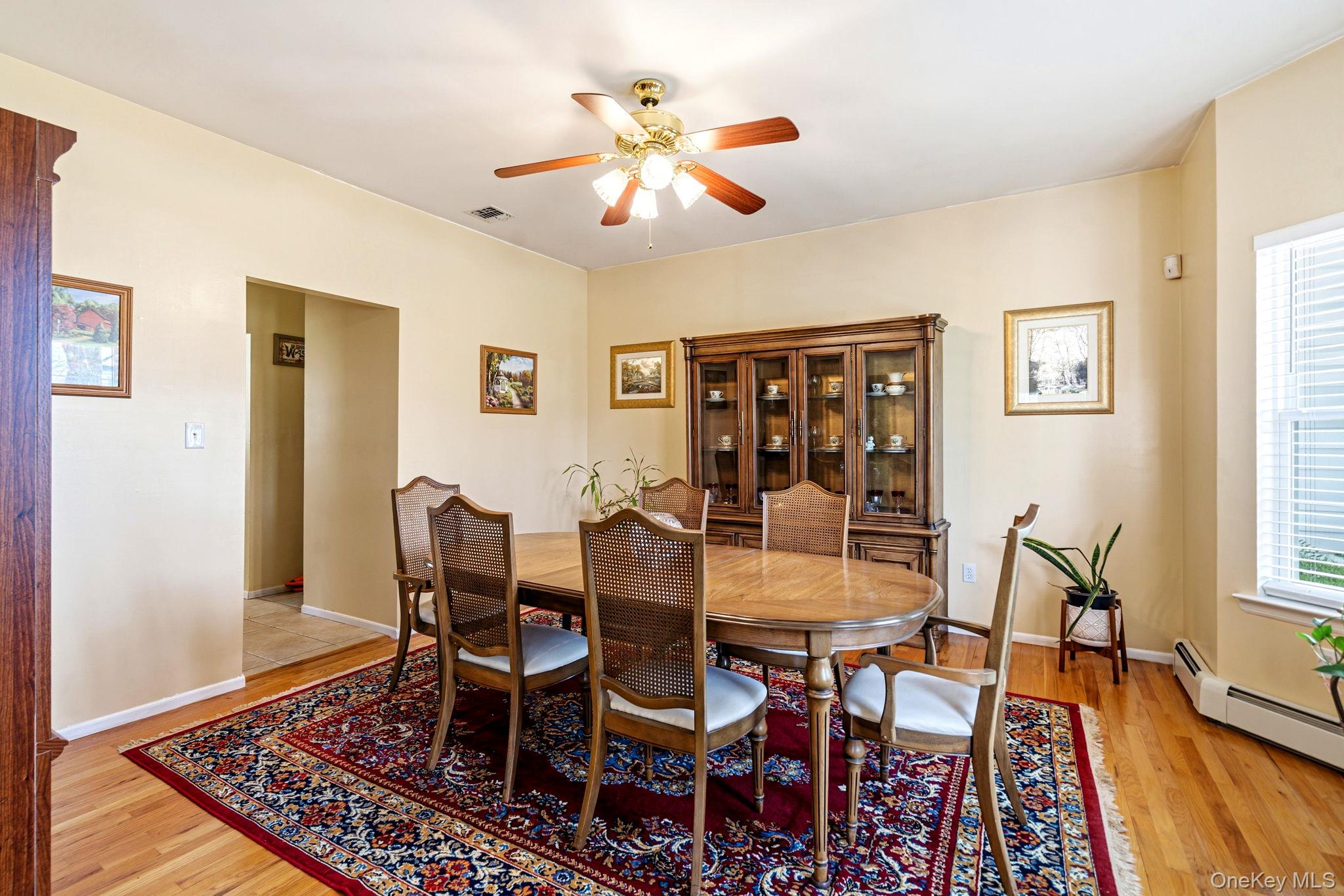 20 Ricky Road Manorville, NY 11949 - Photo 8 of 27 a view of a dining room with furniture and wooden floor