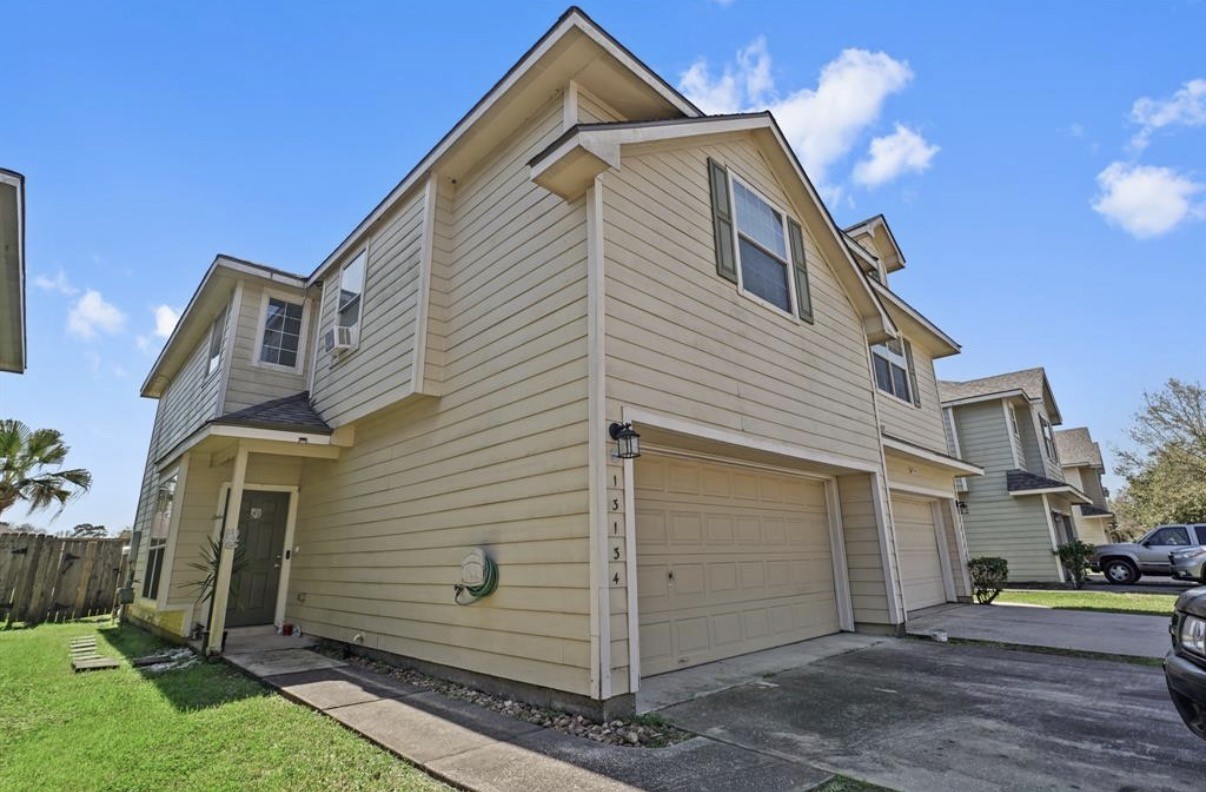 13134 Peppergate Lane Houston, TX 77044 - Photo 1 of 23 a view of a house with a yard