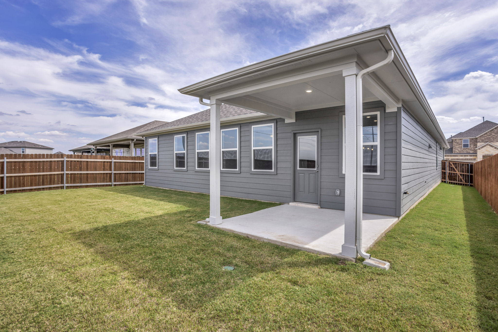 131 Adeline Road Hutto, TX 78634 - Photo 29 of 30 A covered patio extends from this home, inviting outdoor relaxation within a fenced backyard.