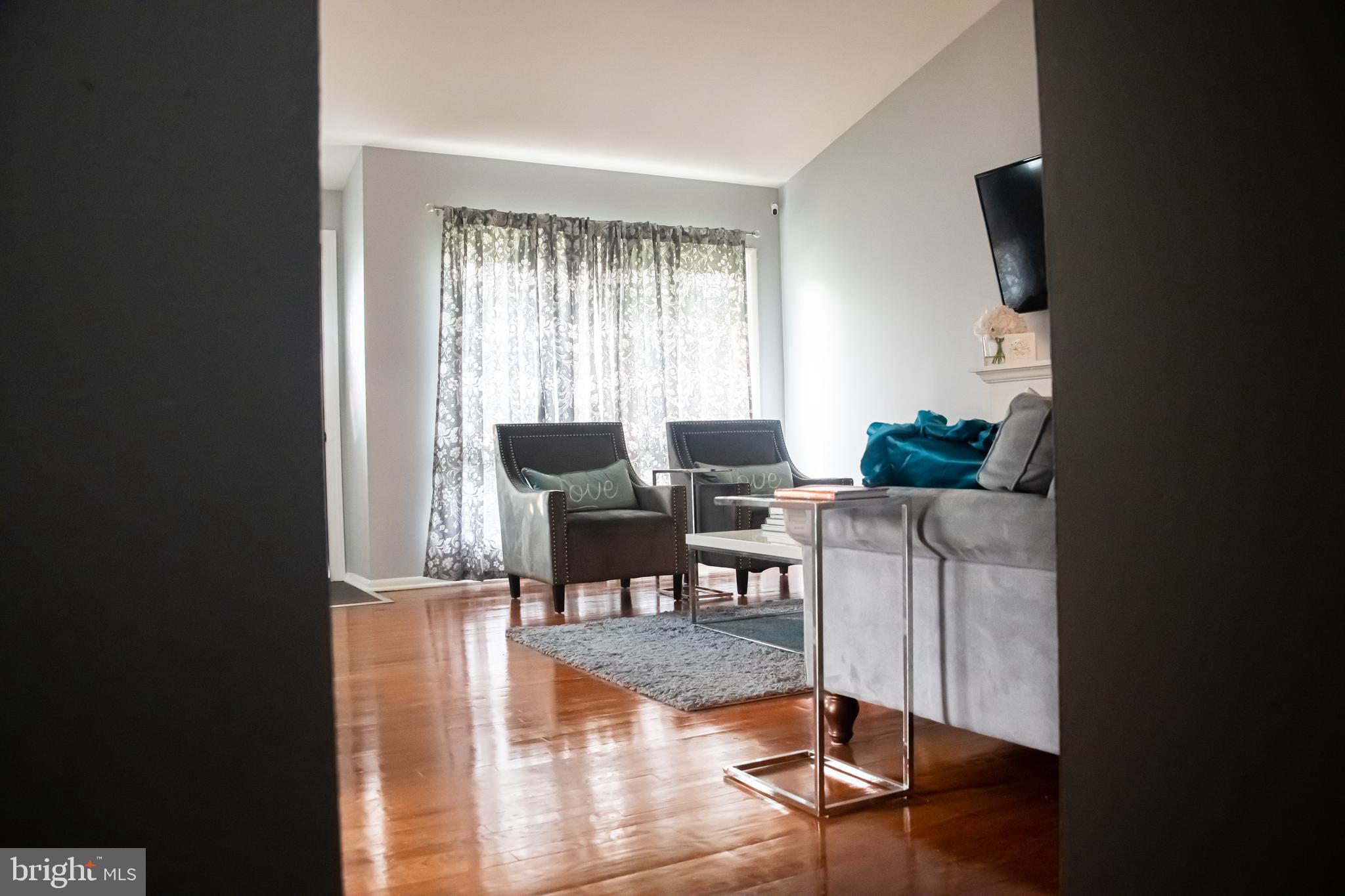3403 Keston Road Baltimore, MD 21207 - Photo 7 of 36 Living room w/ hardwood floors & vaulted ceiling.
