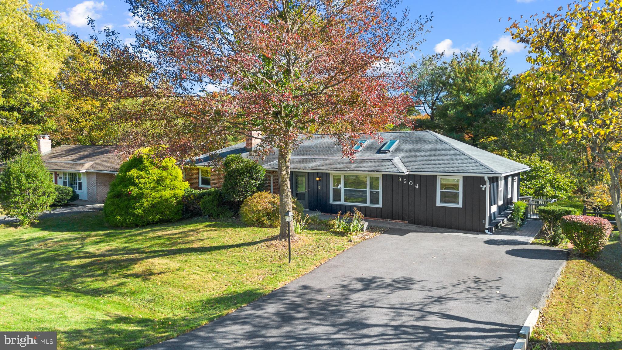 a front view of a house with a yard table and chairs
