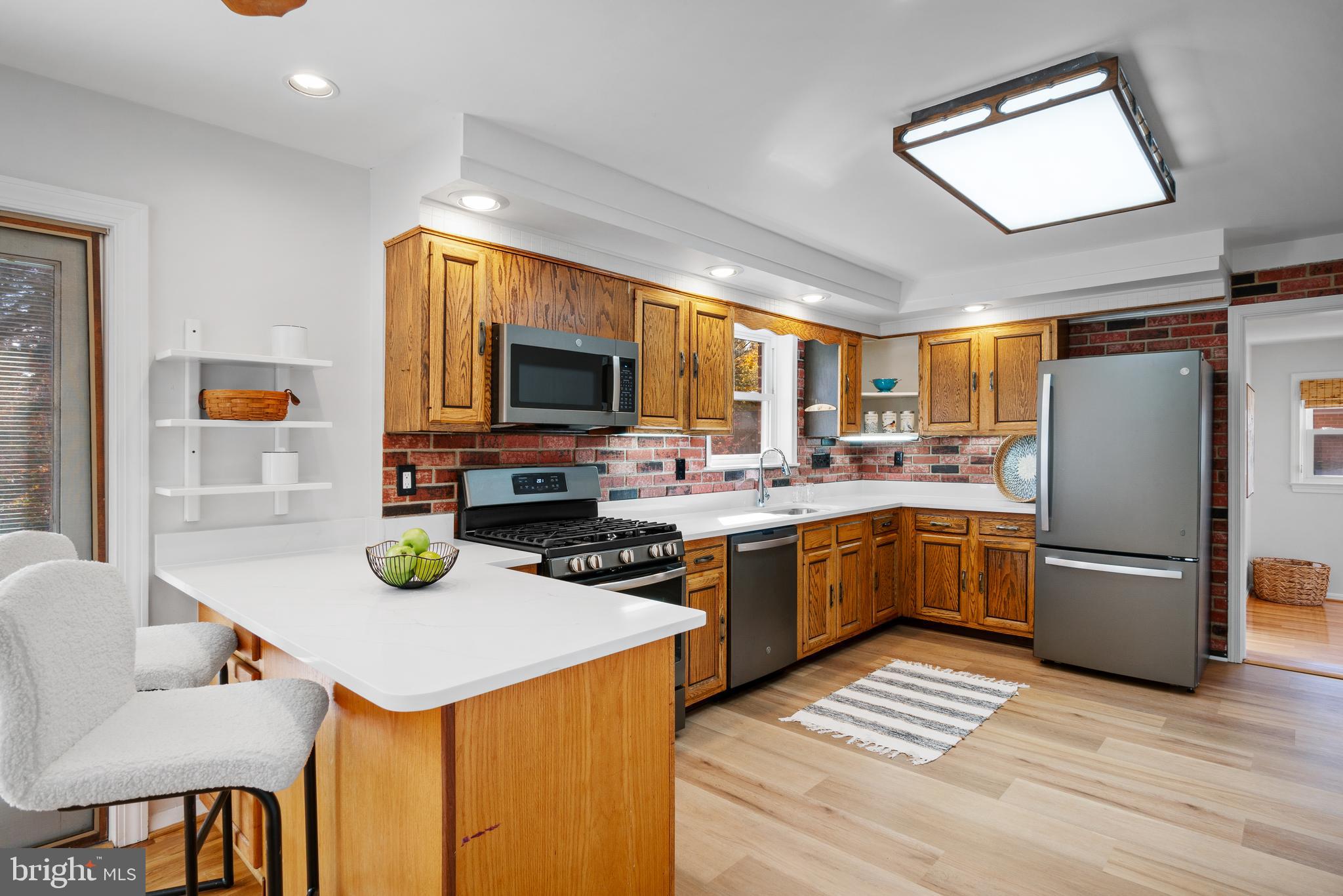 3504 Falling Green Road Olney, MD 20832 - Photo 12 of 54 a kitchen that has a sink stainless steel appliances and cabinets