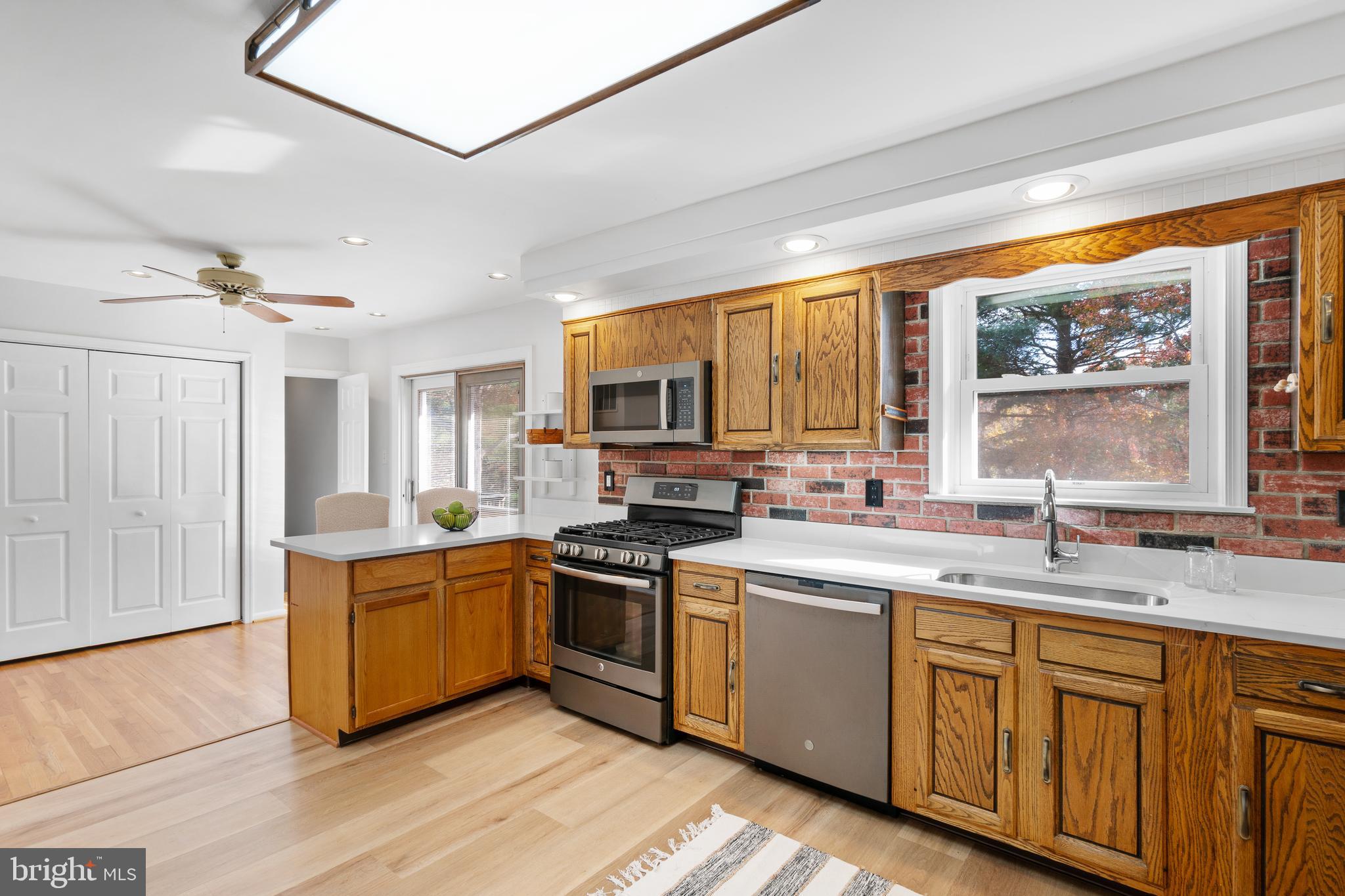 3504 Falling Green Road Olney, MD 20832 - Photo 15 of 54 a kitchen with stainless steel appliances granite countertop wooden cabinets a sink and a stove