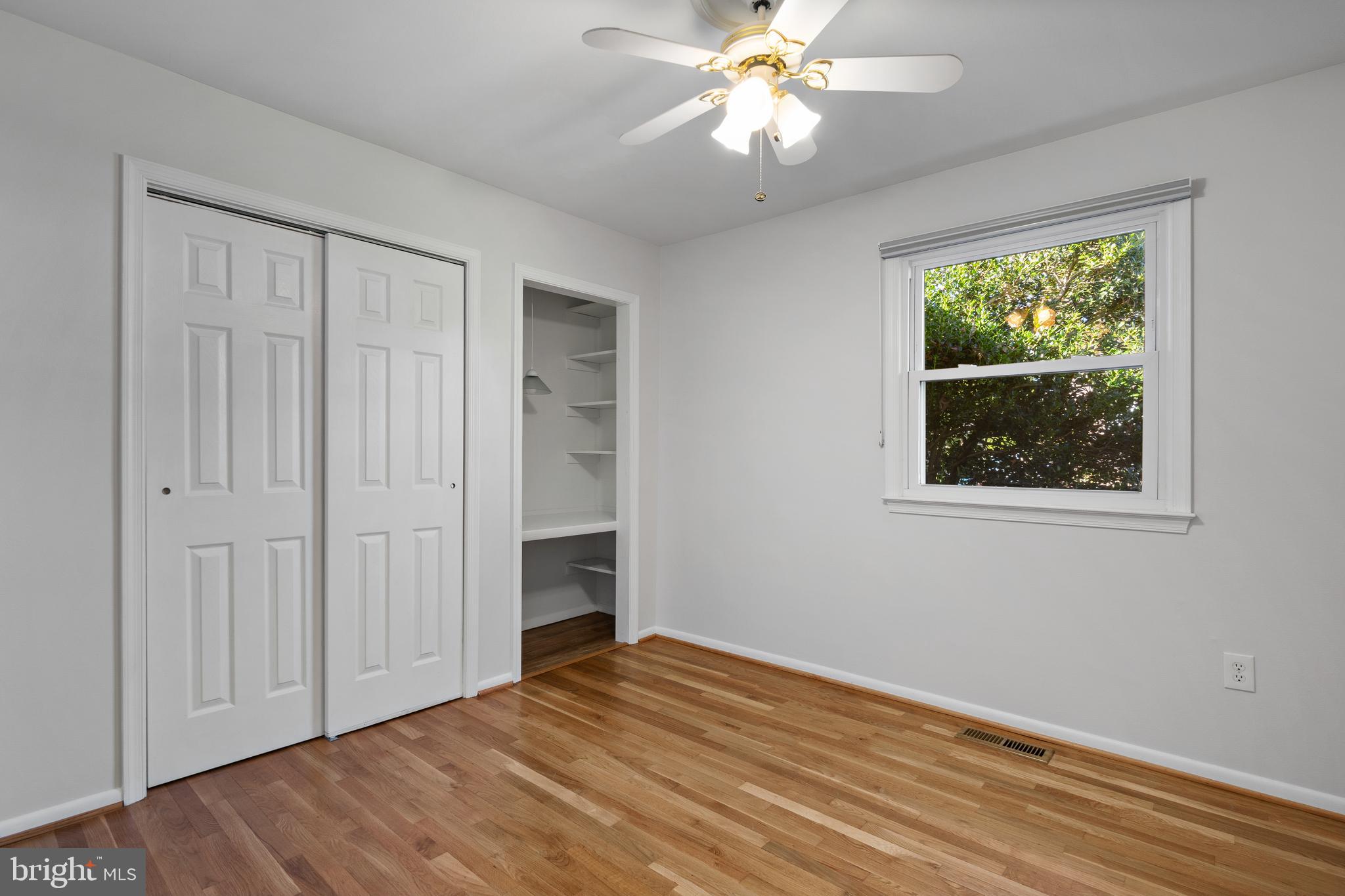 3504 Falling Green Road Olney, MD 20832 - Photo 25 of 54 a view of an empty room with a window and wooden floor