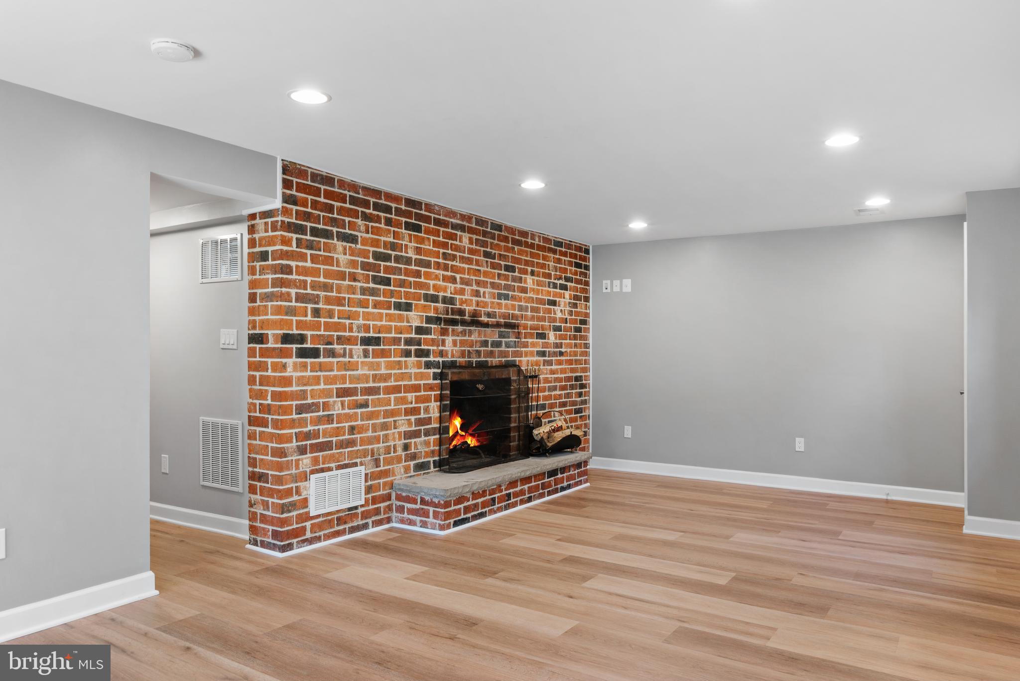 3504 Falling Green Road Olney, MD 20832 - Photo 34 of 54 a view of an empty room with wooden floor and fireplace