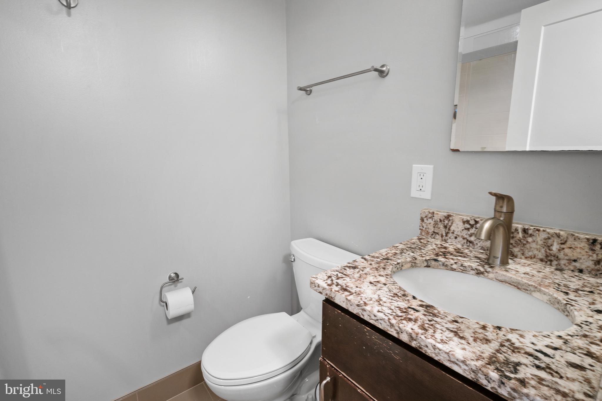 3504 Falling Green Road Olney, MD 20832 - Photo 36 of 54 a bathroom with a granite countertop sink a toilet and mirror