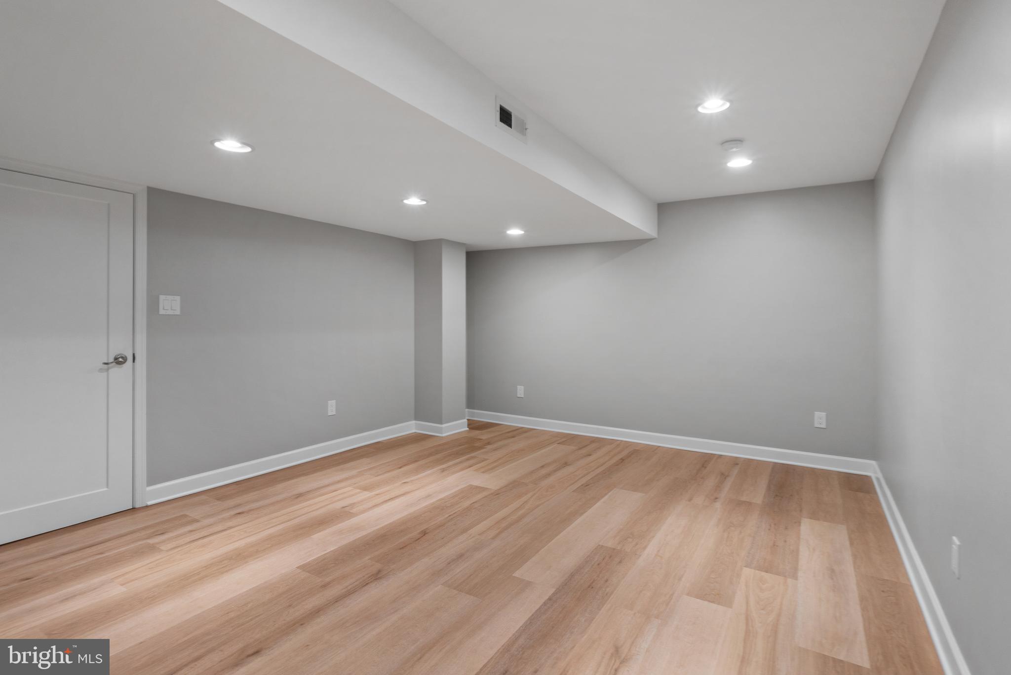 3504 Falling Green Road Olney, MD 20832 - Photo 40 of 54 an empty room with wooden floor and natural light