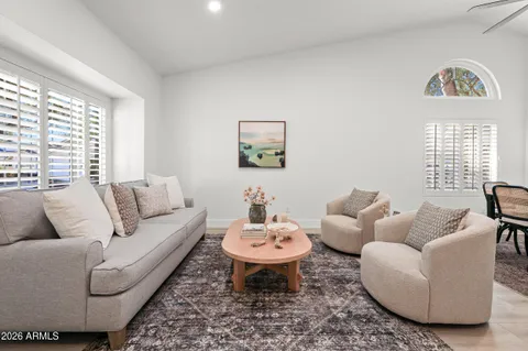 a living room with furniture and a view of kitchen