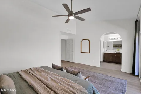 a spacious bedroom with a bed and a large window