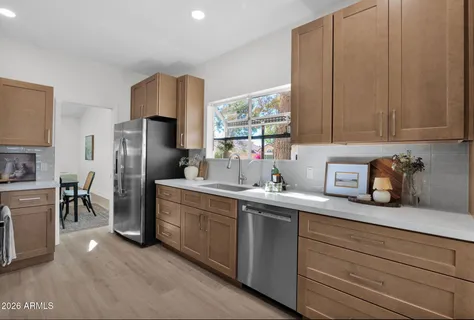 a kitchen with stainless steel appliances a refrigerator and a sink