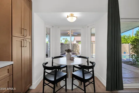 a kitchen with kitchen island granite countertop a sink a stove cabinets and wooden floor