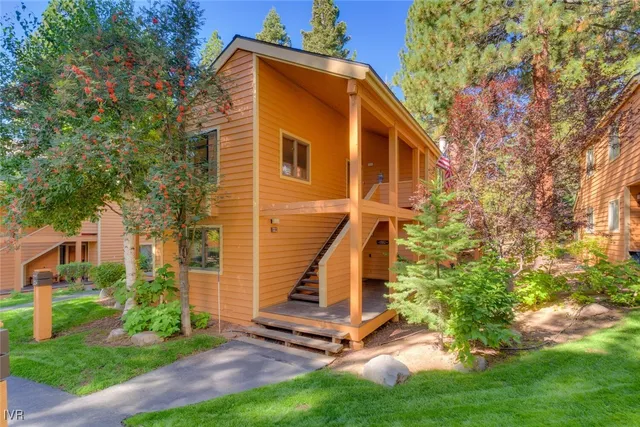 a view of a small house with a yard