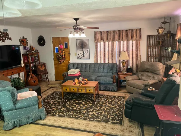a living room with furniture and a chandelier