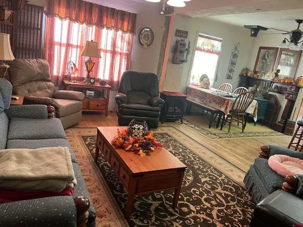 a living room with furniture fireplace and a large window