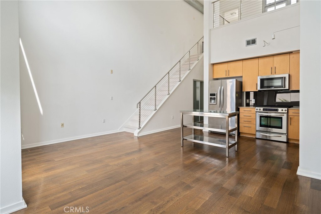 133 The, Unit 404 Long Beach, CA 90802 - Photo 11 of 27 a view of a kitchen with furniture and wooden floor