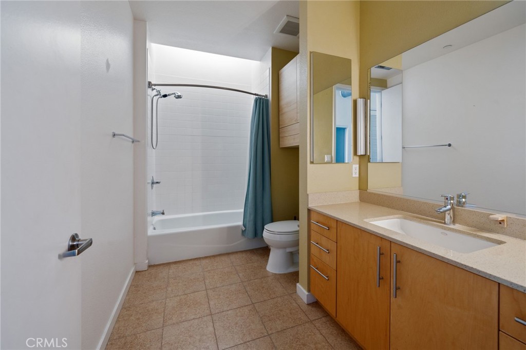 133 The, Unit 404 Long Beach, CA 90802 - Photo 8 of 27 a bathroom with a granite countertop sink a toilet and shower