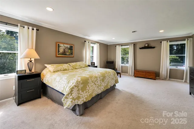 a spacious bedroom with a bed and a cabinets