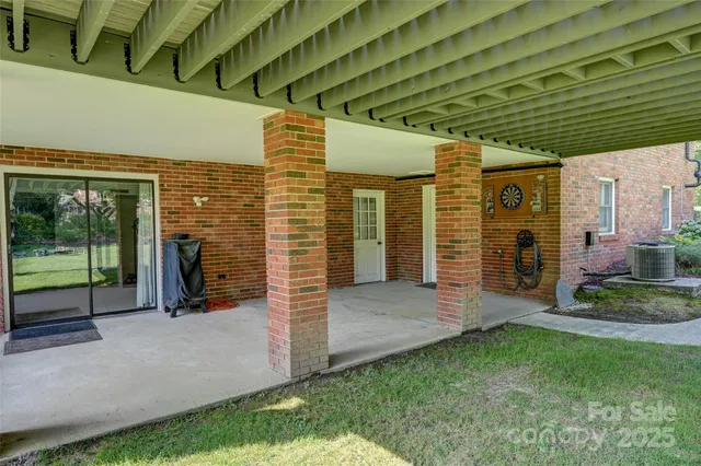 a view of a porch with furniture and a yard