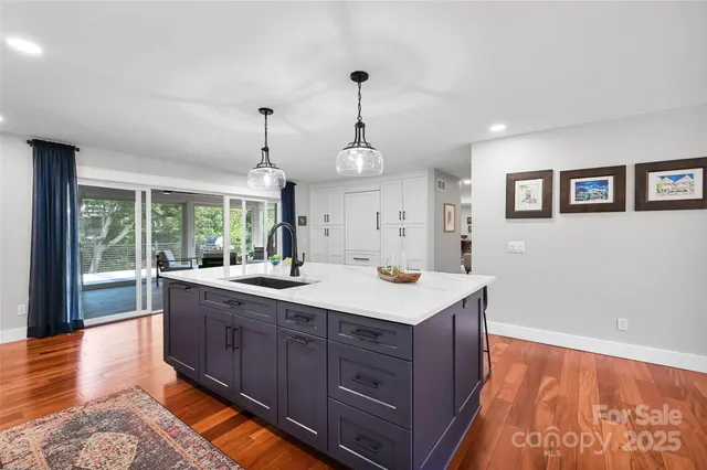 a view of living room with granite countertop furniture and wooden floor