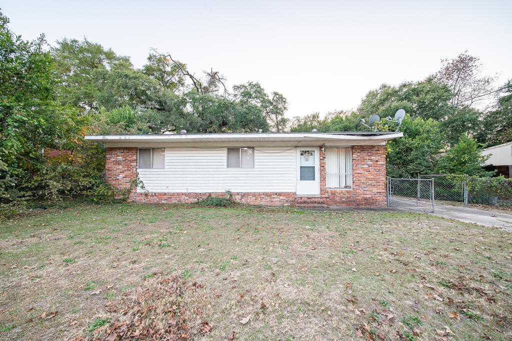 a backyard of a house with barbeque oven