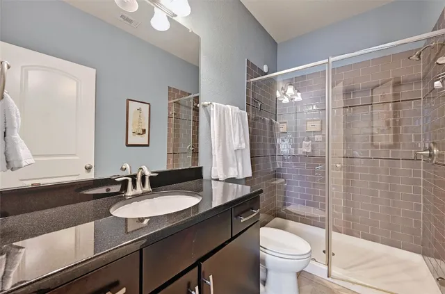 a bathroom with a sink toilet and shower