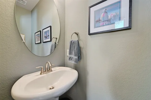 a bathroom with a sink and mirror