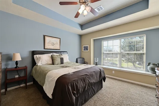 a bedroom with a large bed and a large window