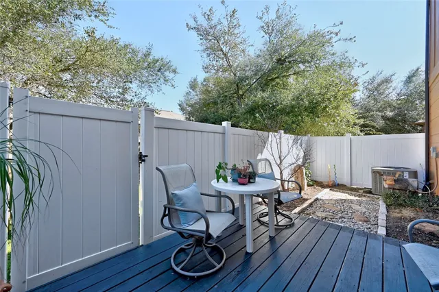 a view of a dinning table and chairs in patio of the house