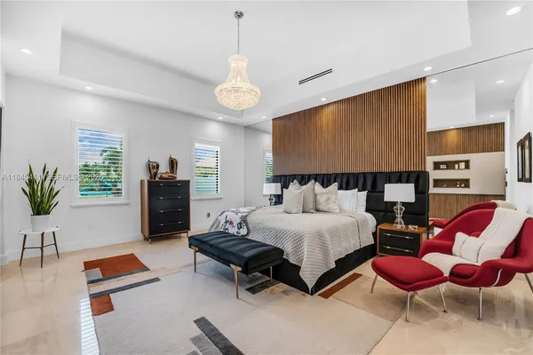 a bedroom with a bed a chandelier and closet