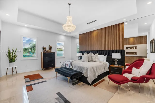 a bedroom with a bed a chandelier and closet