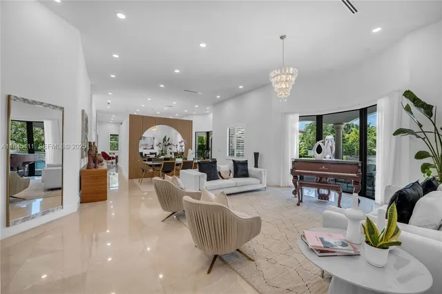 a living room with fireplace furniture and a chandelier