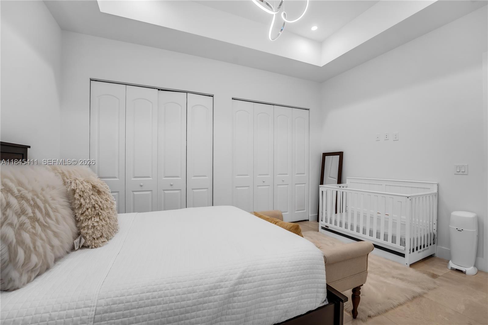 331 Southwest 124th Avenue Miami, FL 33184 - Photo 37 of 69 a bedroom with a bed a chandelier and closet